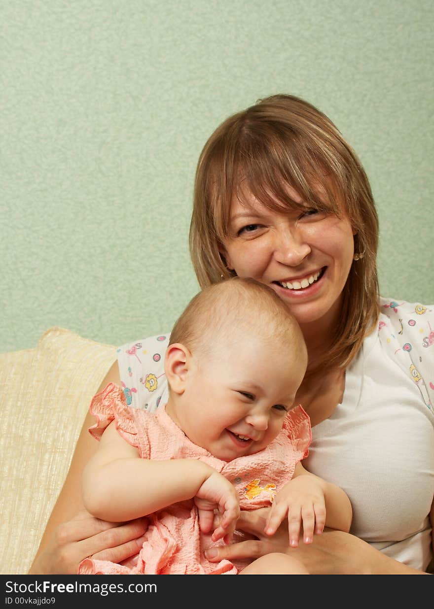 Smiling mother with the child on a green background. Smiling mother with the child on a green background