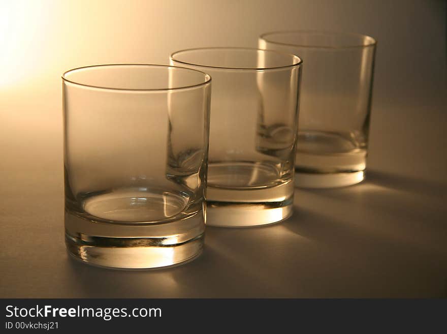 Three empty cognac glasses, distance blur. Three empty cognac glasses, distance blur