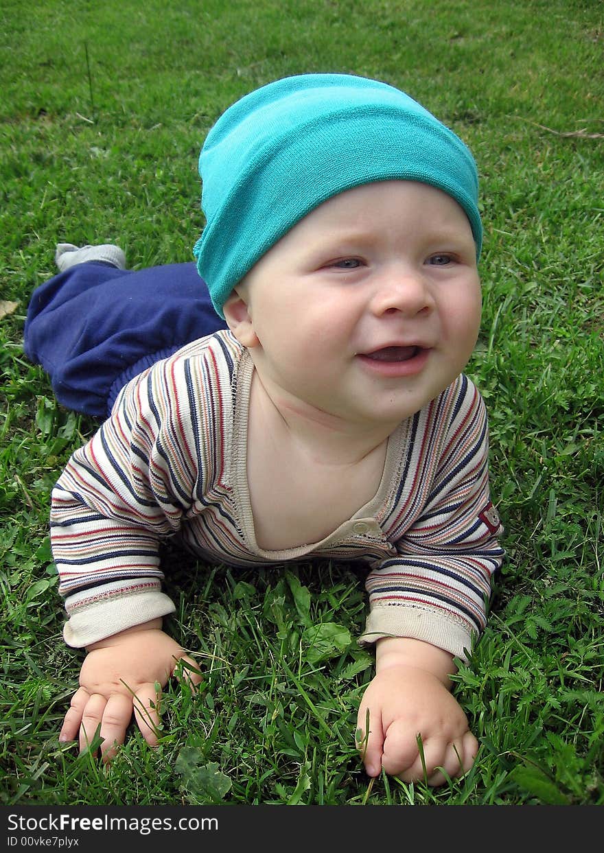 Baby boy is crawling in grass. Baby boy is crawling in grass