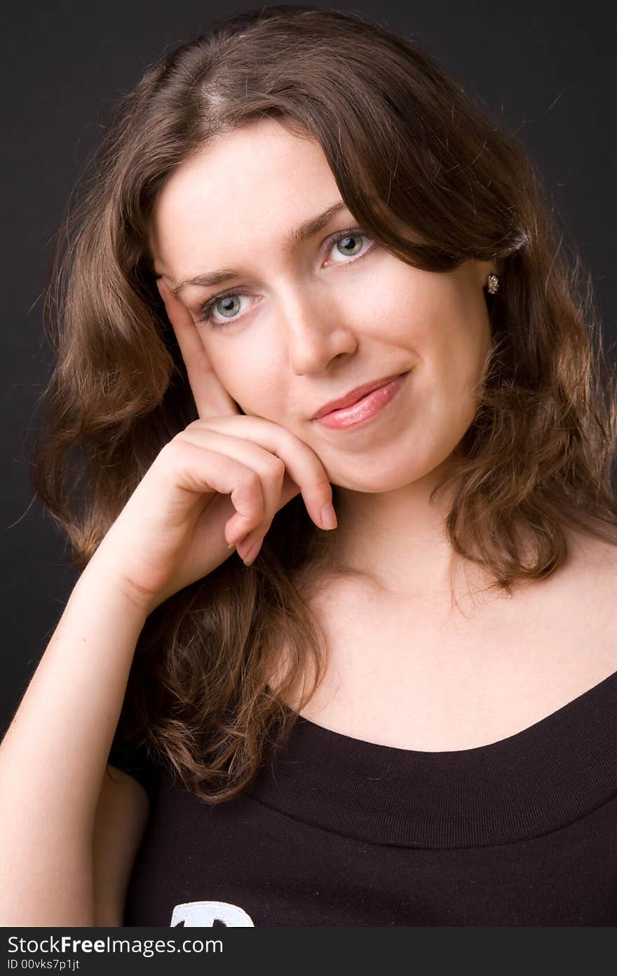 The beautiful girl in studio on a black background.