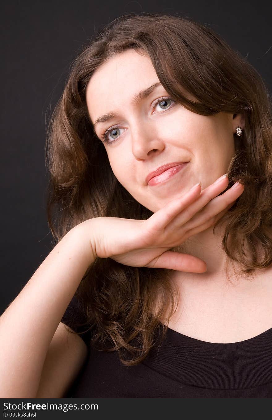 The beautiful girl in studio on a black background.