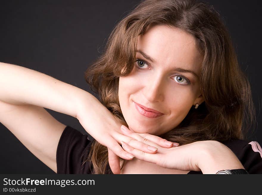 The beautiful girl in studio on a black background.