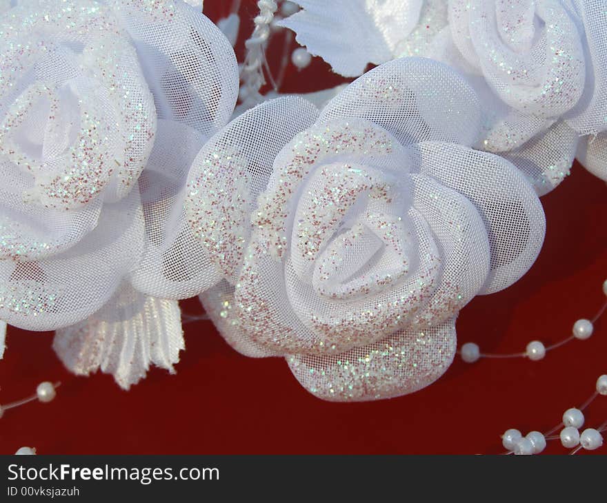 White wedding roses are decorated with beads. White wedding roses are decorated with beads.