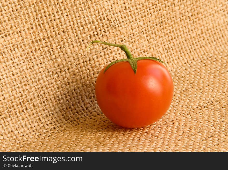 One small tomato at the canvas background