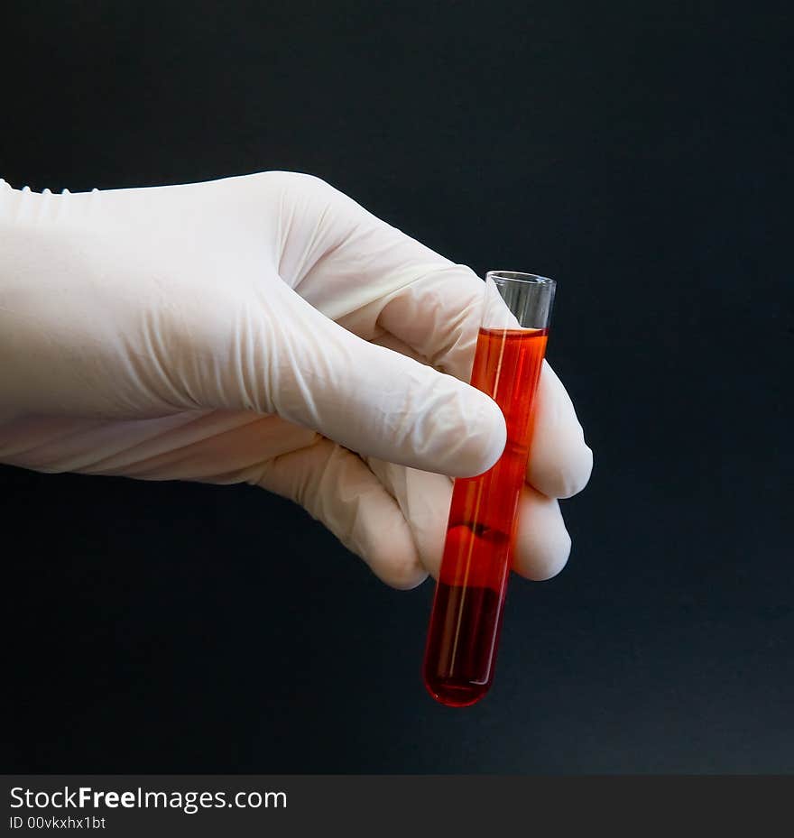 Gloved Hand Holding Test Tube