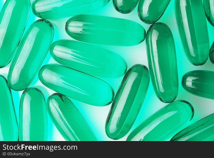 Green capsules on white background, horizontal image. Green capsules on white background, horizontal image