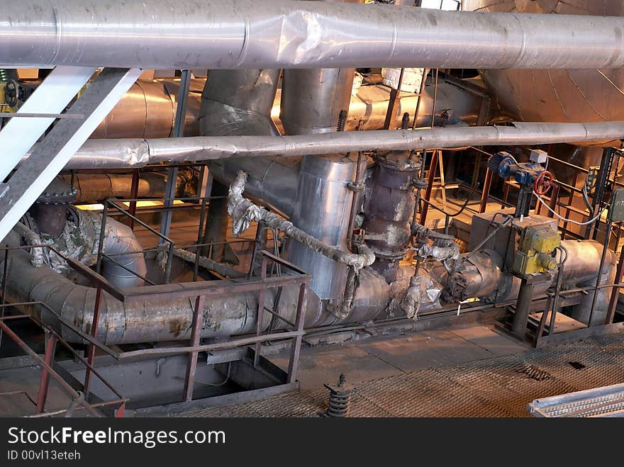 Equipment, cables and piping as found inside of a modern industrial power plant