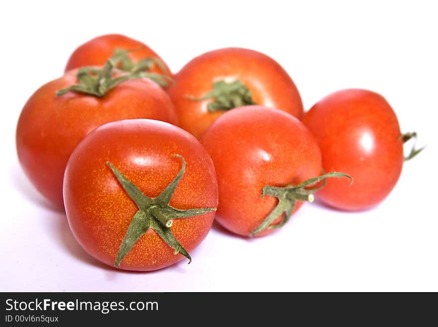 Several tomatos isolated on a white background. Several tomatos isolated on a white background.