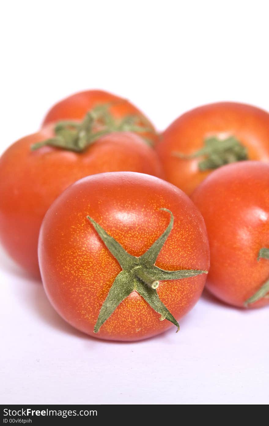 Several tomatos isolated on a white background. Several tomatos isolated on a white background.