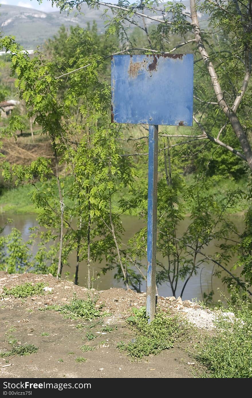 Blank blue sign on nature. Can be used for latter text.