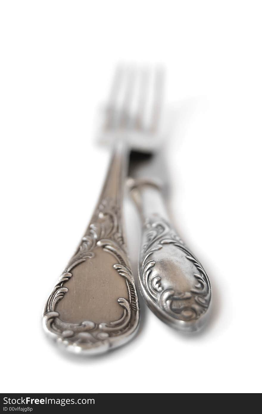 Ancient silver fork and knife isolated over white. Ancient silver fork and knife isolated over white