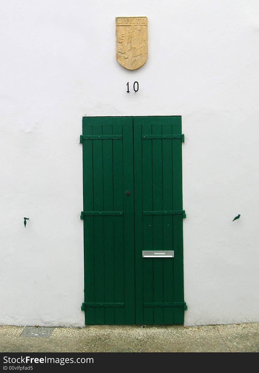 A green wooden door in France.