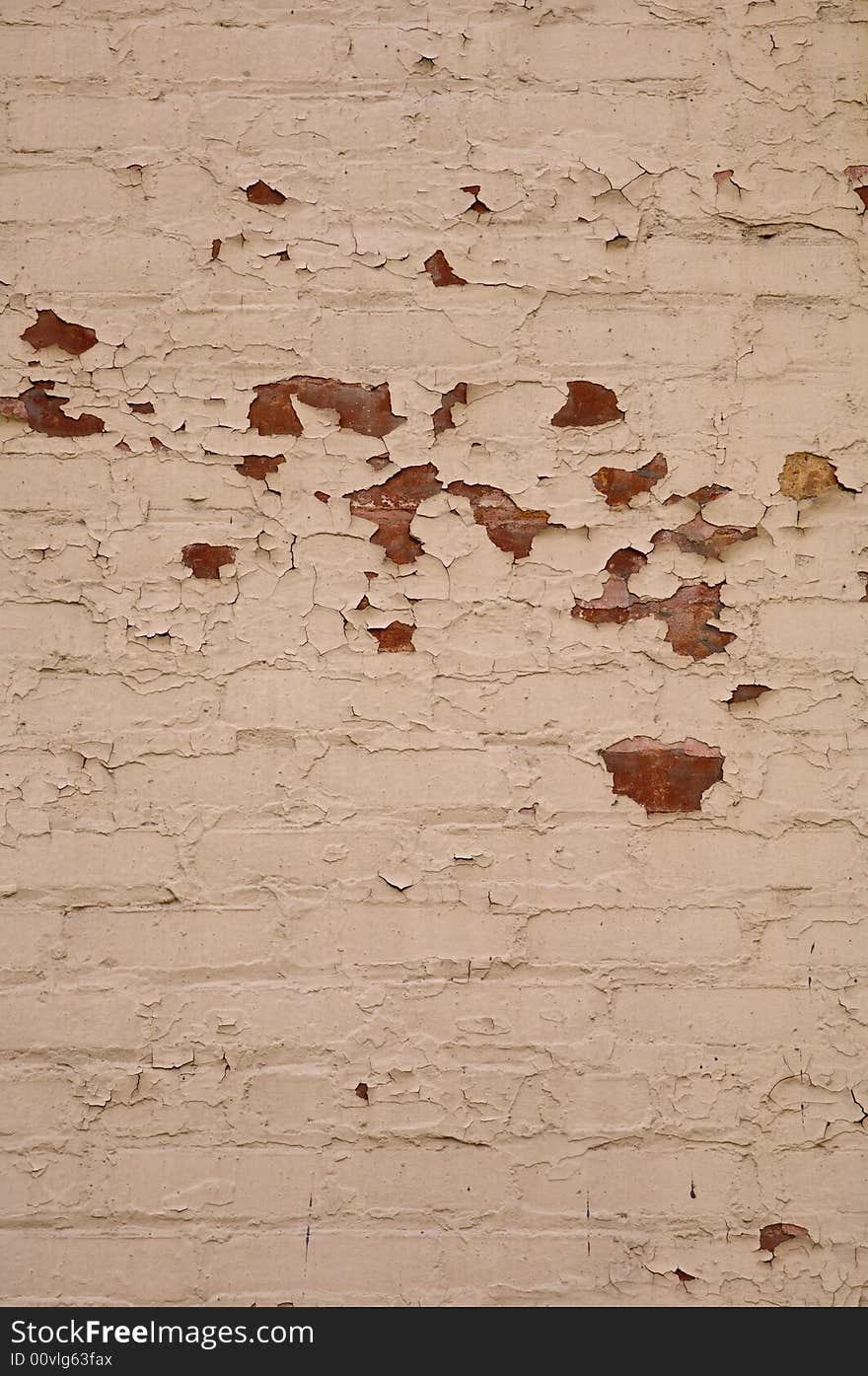 Light brown brick wall that could be used for a background with lots of texture and peeling paint. Light brown brick wall that could be used for a background with lots of texture and peeling paint