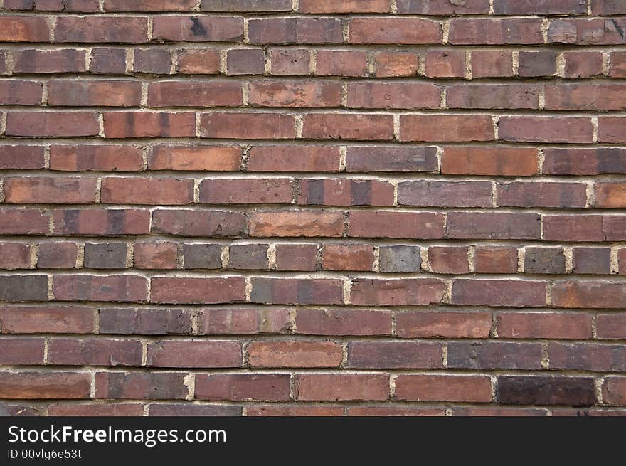 Dark brown red brick wall