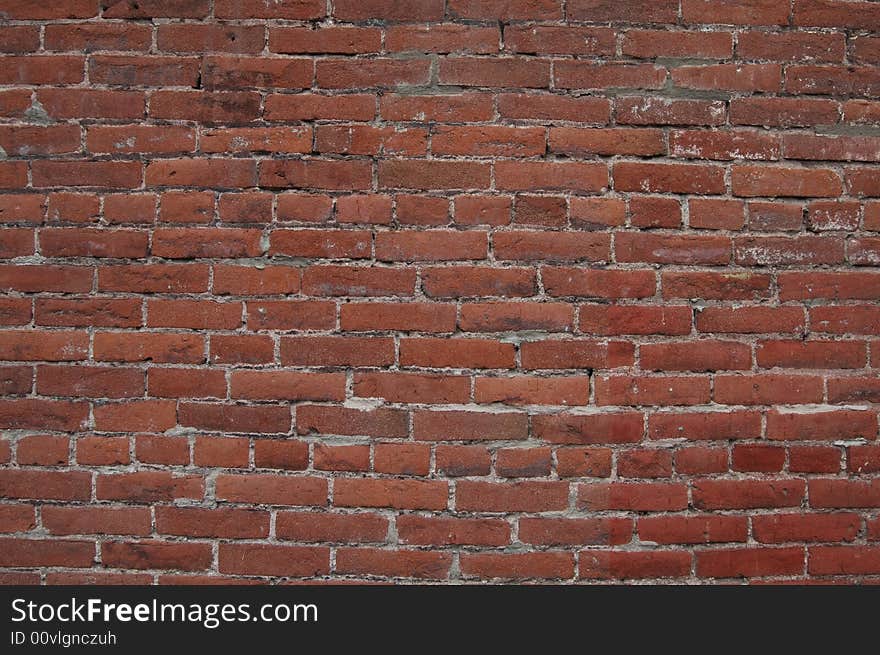 Dark red brick wall that could be used for a background. Dark red brick wall that could be used for a background