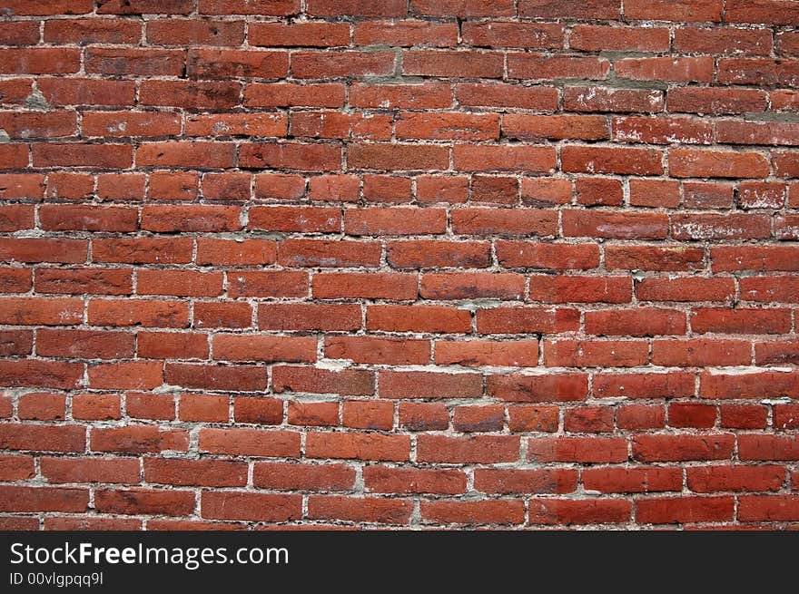 Dark red brick wall that could be used for a background. Dark red brick wall that could be used for a background