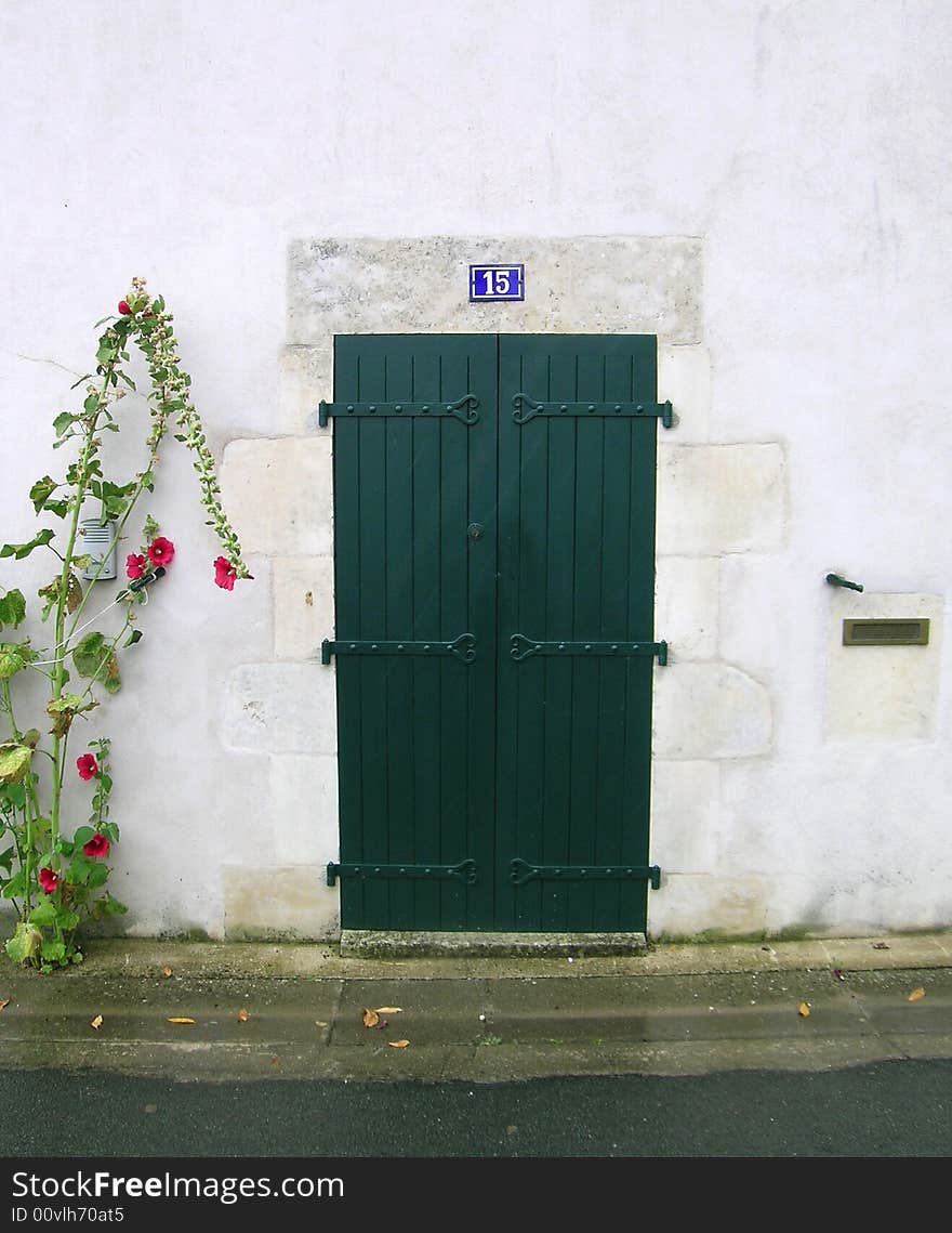 A green wooden door in France.