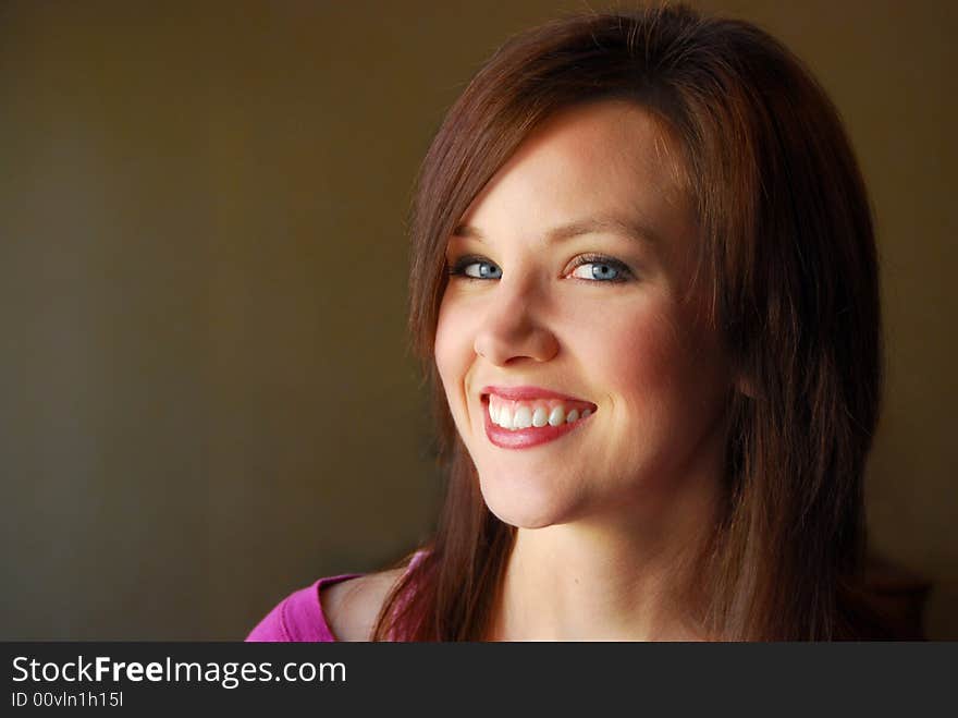 Portrait of young beautiful woman smiling with dark background. Portrait of young beautiful woman smiling with dark background