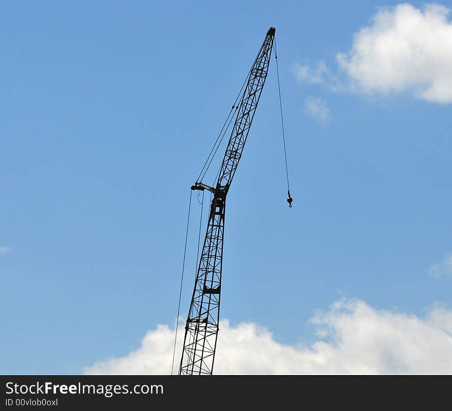 Construction crane highlighted against the sky