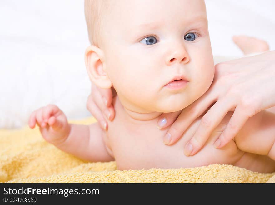 Cute six month baby on yellow blanket. Cute six month baby on yellow blanket