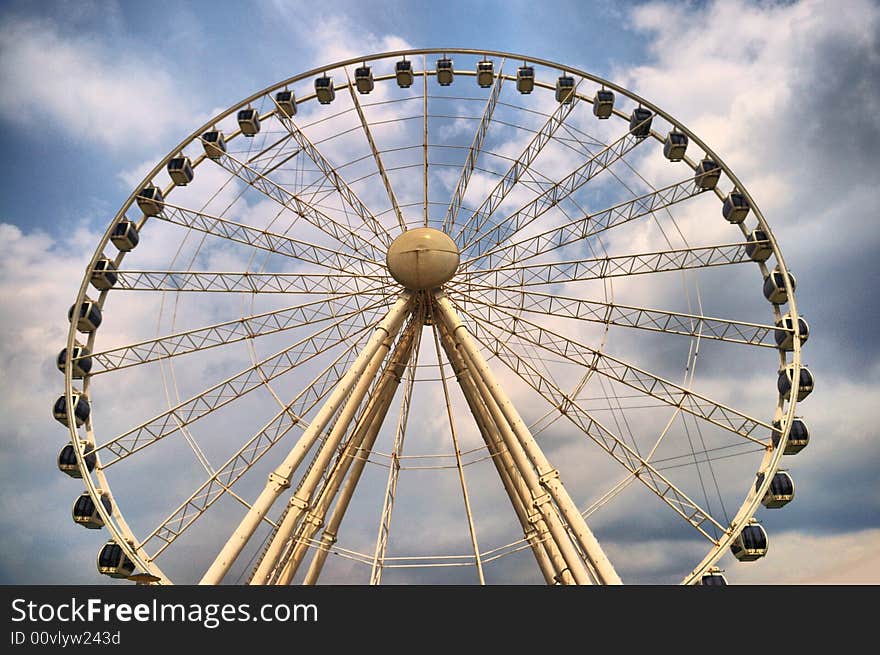 A view of a ferris wheel at an amusement park. A view of a ferris wheel at an amusement park