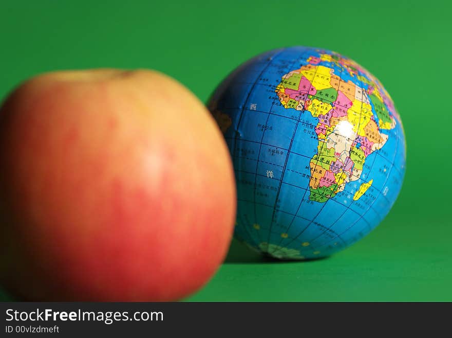 a globe and an apple . a globe and an apple