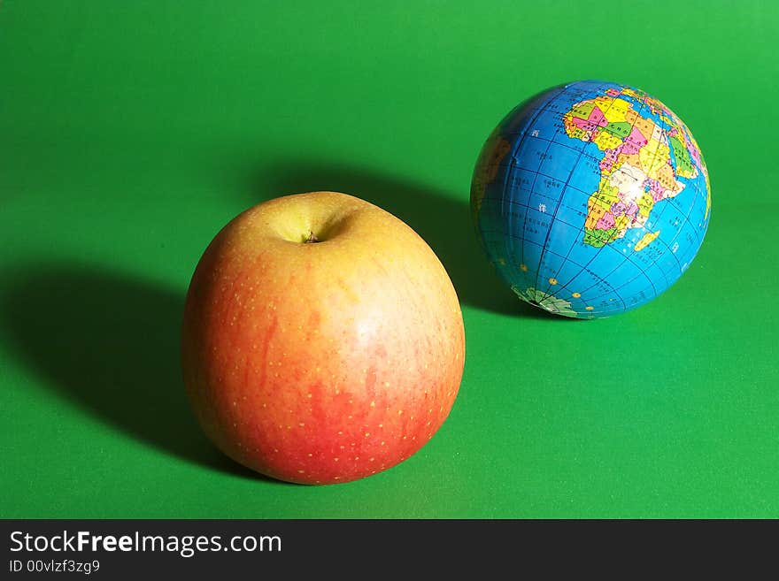 a globe and an apple. a globe and an apple