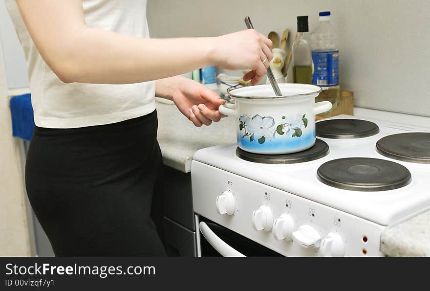 Woman cooking soup in the kitchen. Woman cooking soup in the kitchen