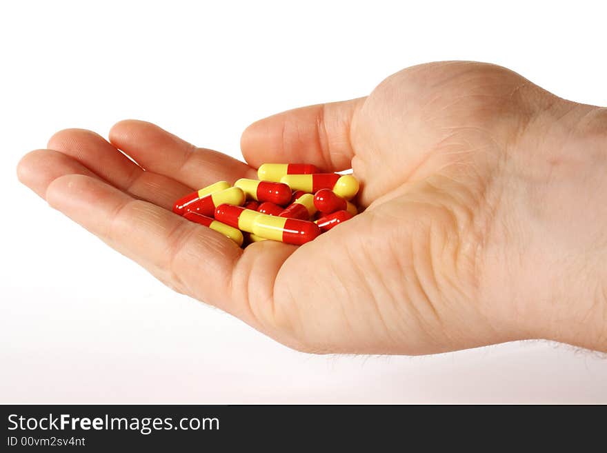 Pills in a hand for healthier living. Pills in a hand for healthier living.