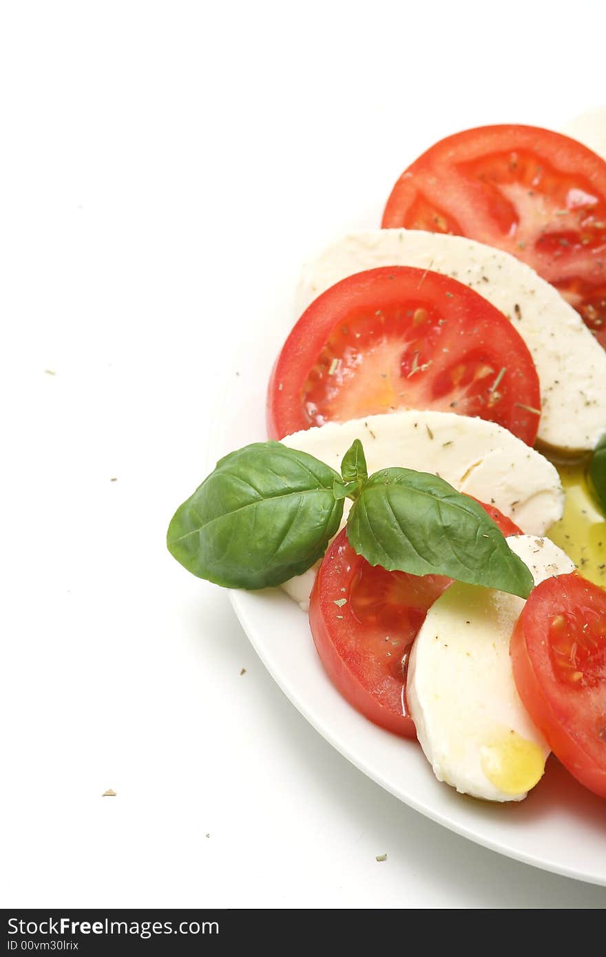 Plate of tricolore salad,mozzarella with tomatoes and basil.
. Plate of tricolore salad,mozzarella with tomatoes and basil.