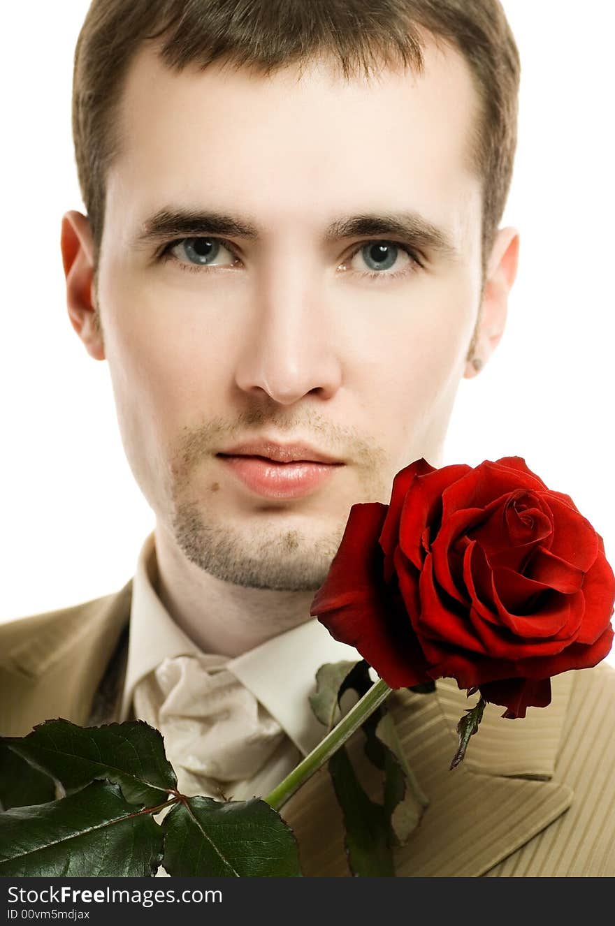 Handsome young man with a rose