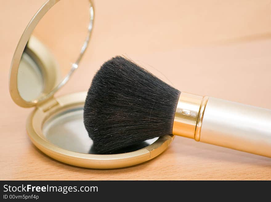 Brush For Makeup Reflected In Mirror On Wooden Tab