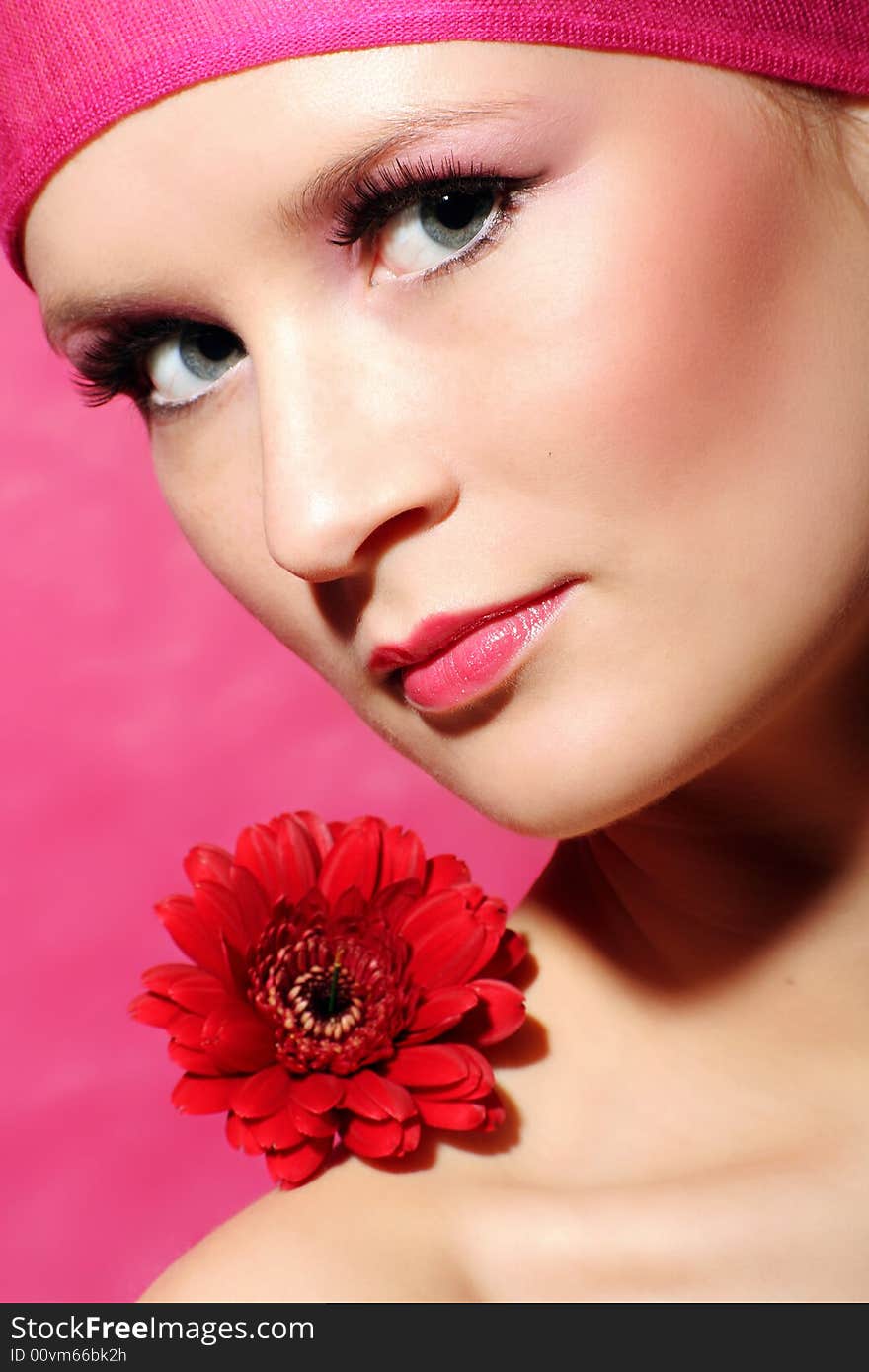 Beauty portrait of a beautiful young woman with a red gerbera flower. Beauty portrait of a beautiful young woman with a red gerbera flower