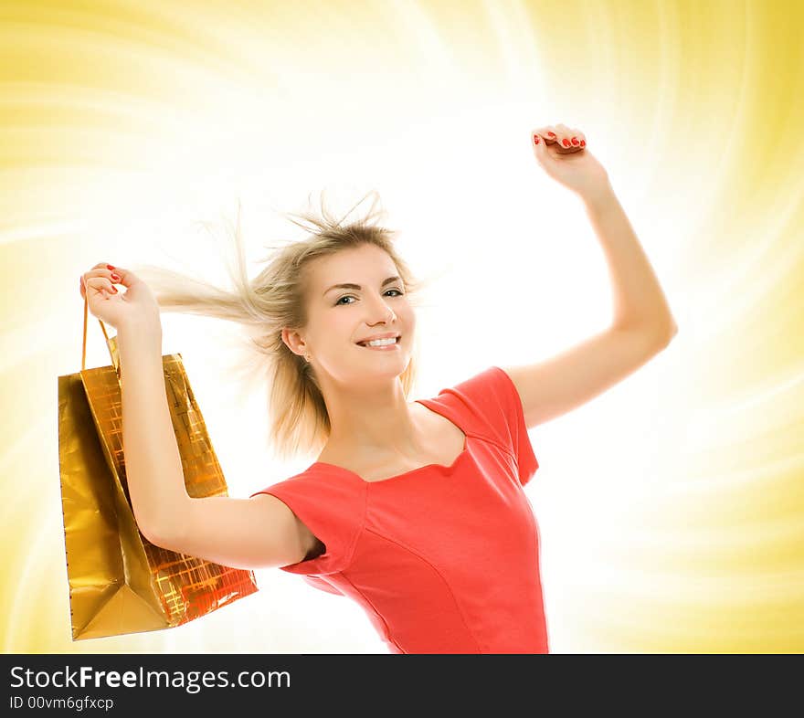 Beautiful young woman with a bag over abstract yellow background