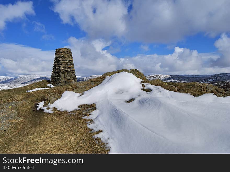 The snow streaked summit and tig point of Brunt Knott, a hill in the English lake District. The snow streaked summit and tig point of Brunt Knott, a hill in the English lake District