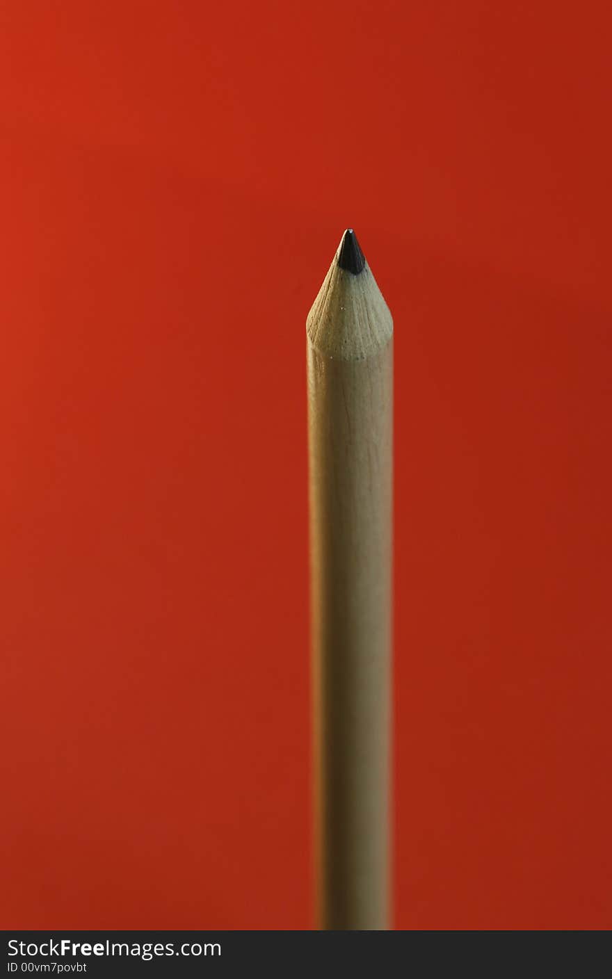 A pencil with a simple red color background