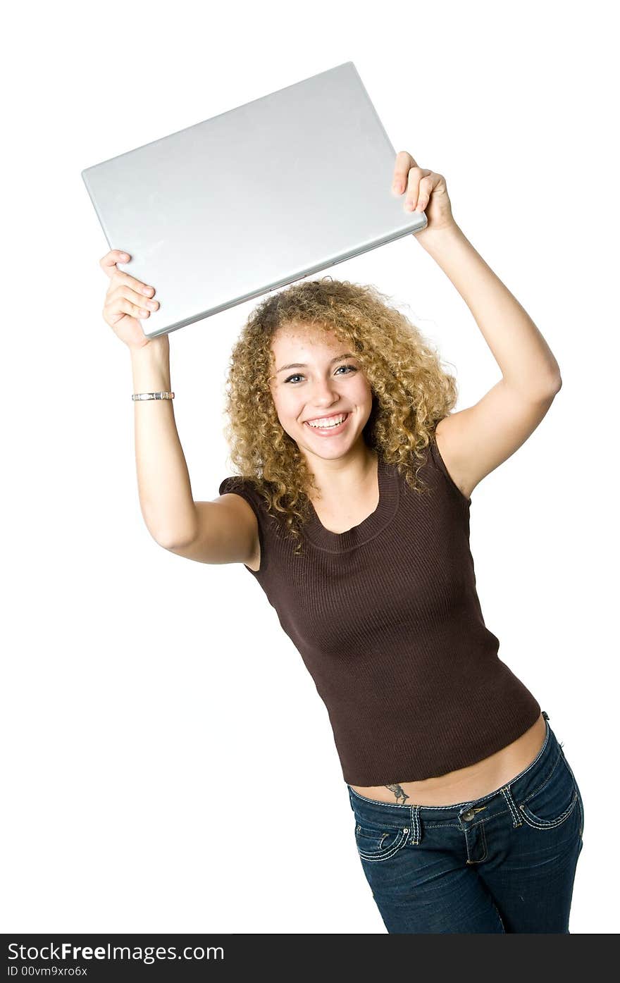 A beautiful young women holding her portable computer above her head. A beautiful young women holding her portable computer above her head