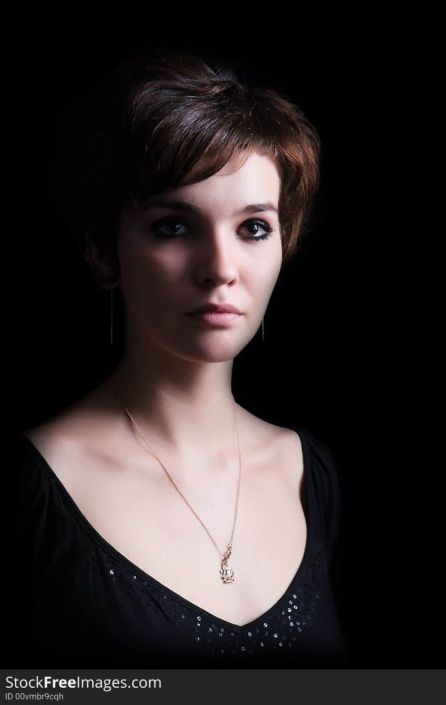 Portrait of the beautiful girl on a black background