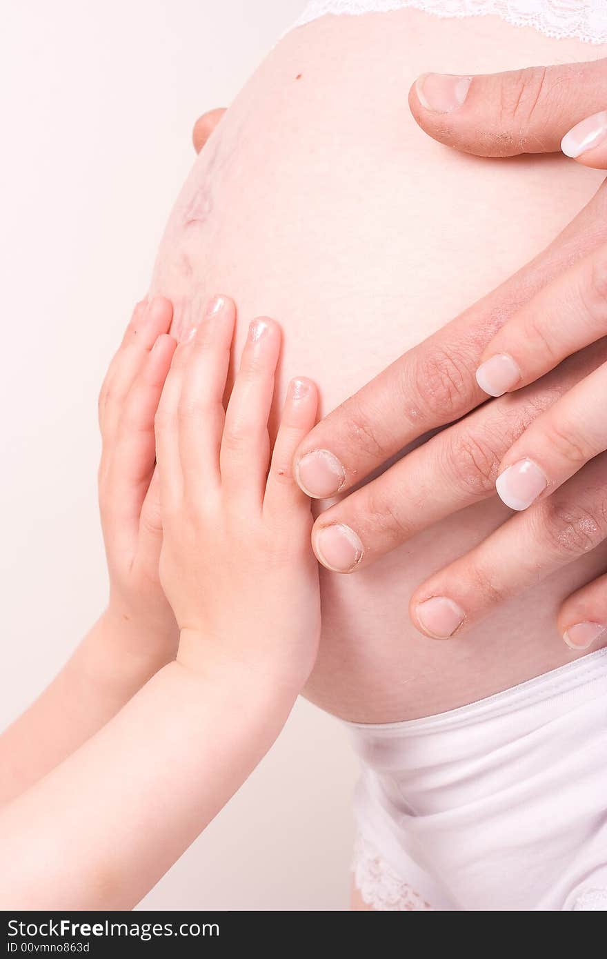 Hands of father, mother and child on pregnant belly. Hands of father, mother and child on pregnant belly