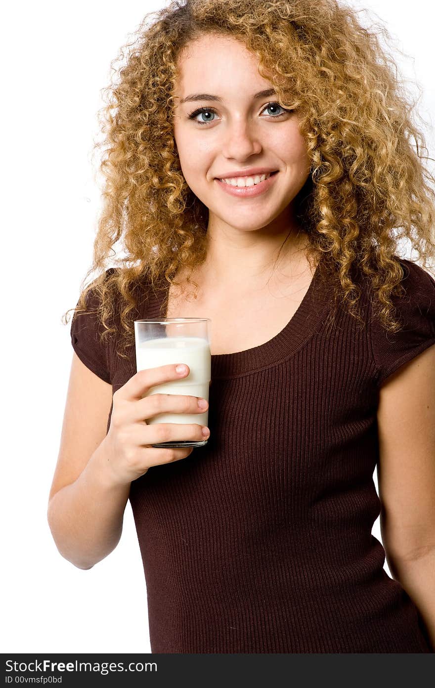 A pretty young woman holding a glass of milk. A pretty young woman holding a glass of milk