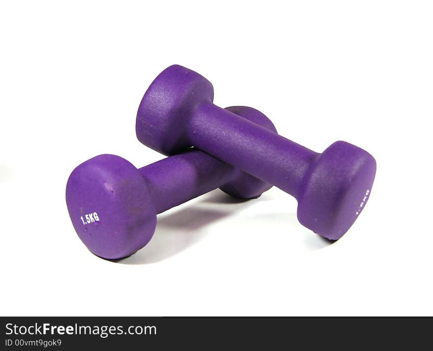 Two dumbbells of violet color in a soft environment in weight of 1,5 kg.