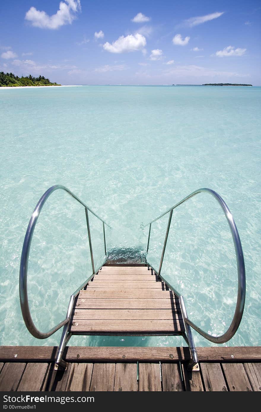 Jetty leading into tropical sea, Maldives