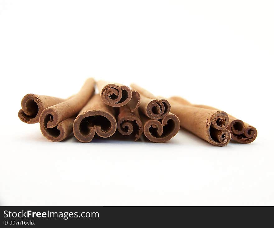 Horizontal image of piled cinnamon sticks, viewed straight on.