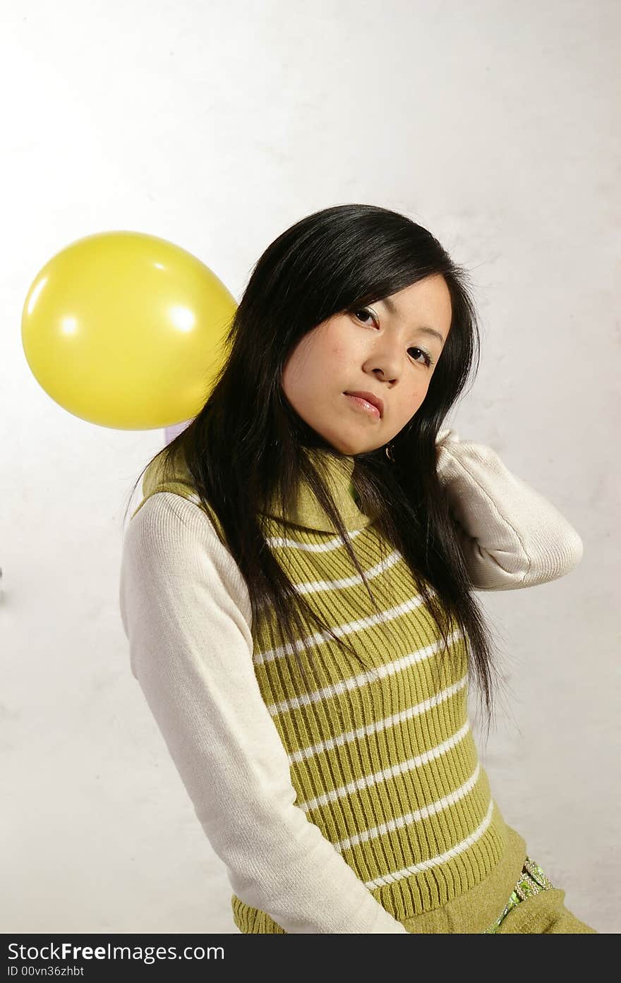 A girl holding a balloon. A girl holding a balloon.