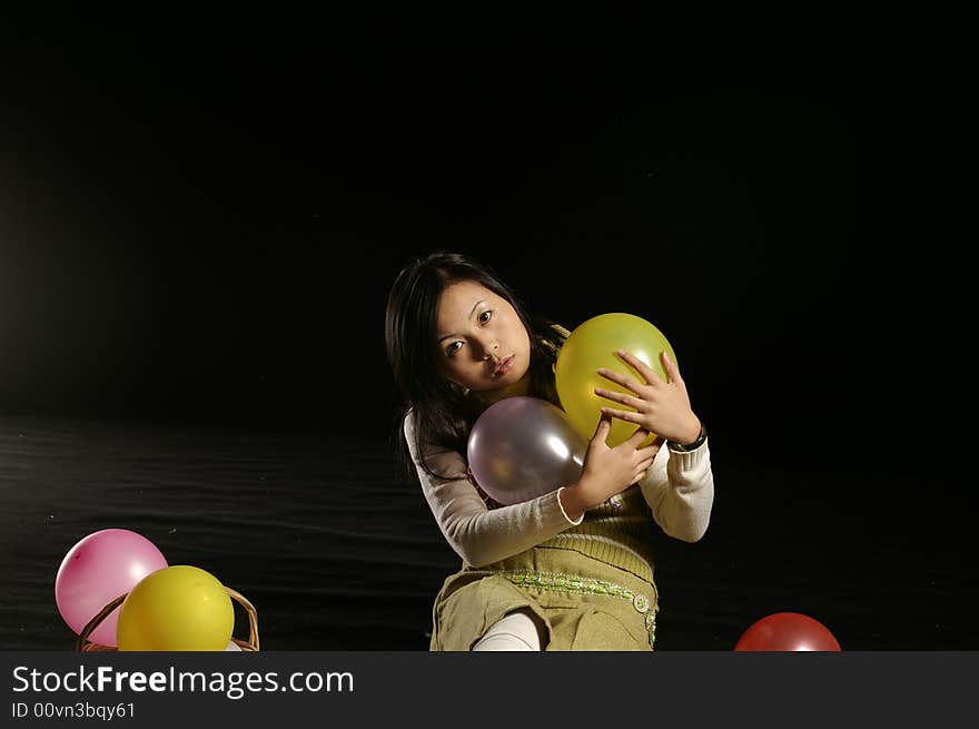 A girl holding the balloons. A girl holding the balloons.