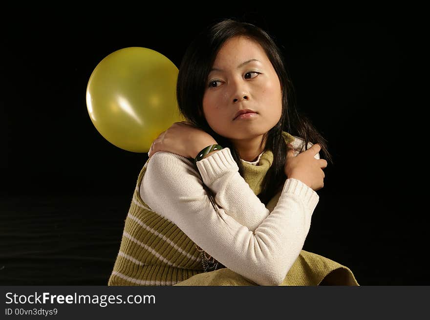 A girl holding a balloon. A girl holding a balloon.