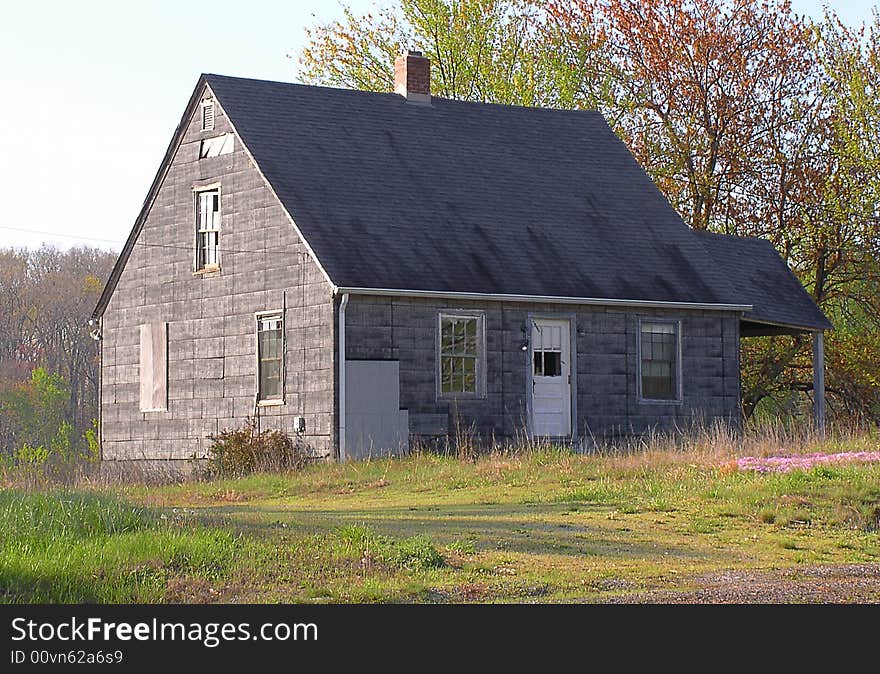 A house in a rural area, found in a state of disrepair. The side porch slumps slightly, some windows are broken and siding missing, but outward appearance is that this could be reinhabited with some repair work. A house in a rural area, found in a state of disrepair. The side porch slumps slightly, some windows are broken and siding missing, but outward appearance is that this could be reinhabited with some repair work.