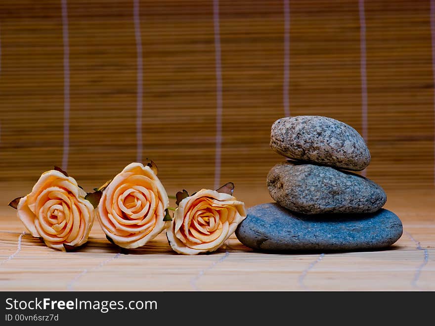 Still life with three round stone and rose