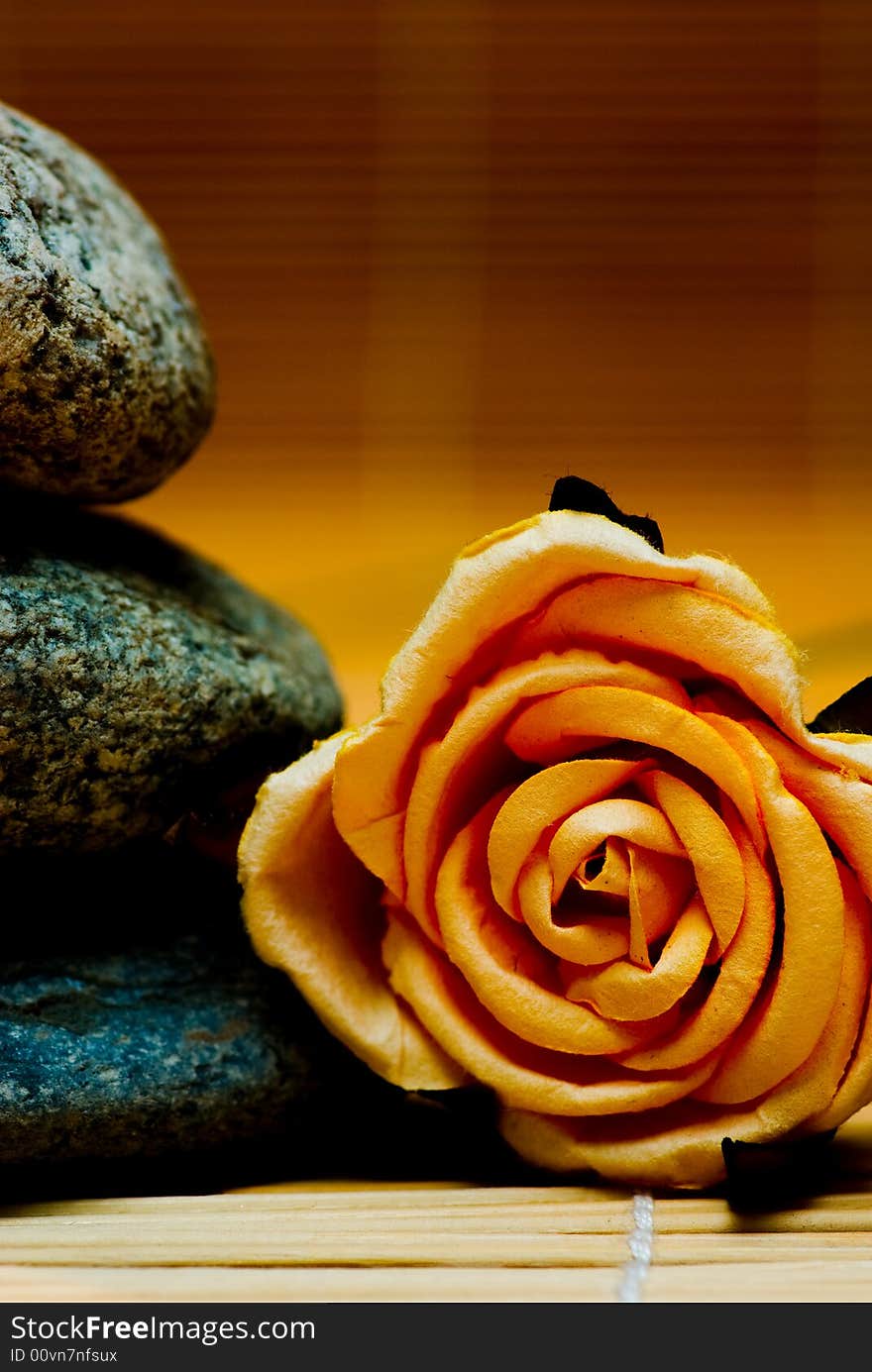 Still life with three round stone and rose