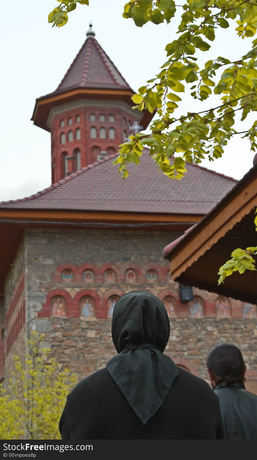 Image of a nun praying in front of a Romanian Monastery. Image of a nun praying in front of a Romanian Monastery.